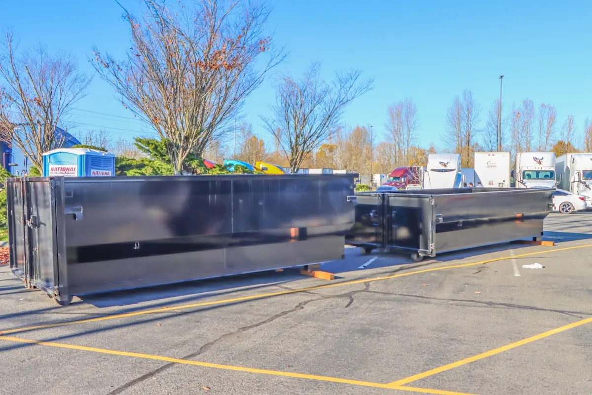 Professional dumpster rental service with roll-off container on residential driveway in Los Alamitos